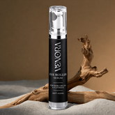 Venora eye roller serum bottle on a textured surface with driftwood