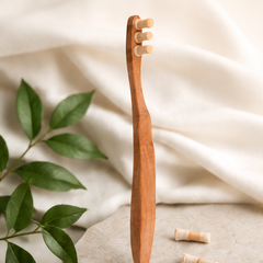Wooden toothbrush with bristle heads on a light fabric background